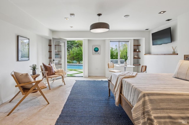 bedroom featuring baseboards and access to exterior