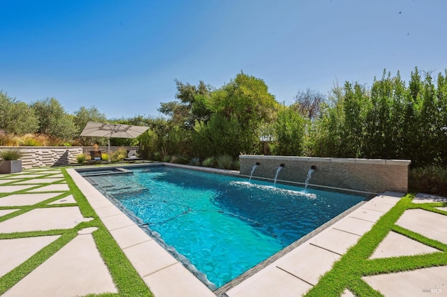 view of pool with a pool with connected hot tub, fence, and a patio