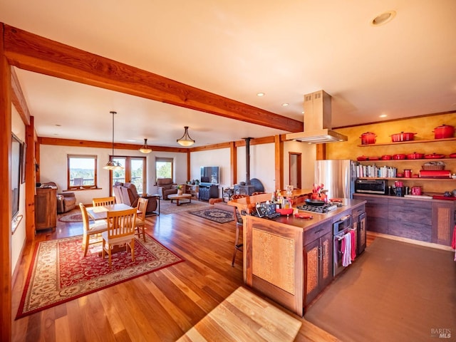 26300 Albion Ridge Rd, Albion, CA 95410 - kitchen with island range hood, wood finished floors, beamed ceiling, and appliances with stainless steel finishes