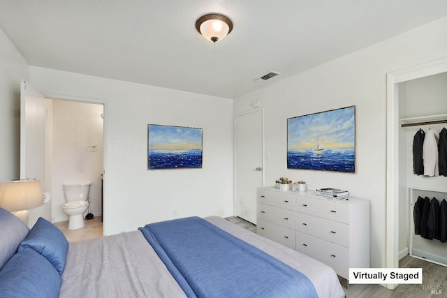 bedroom featuring visible vents and connected bathroom
