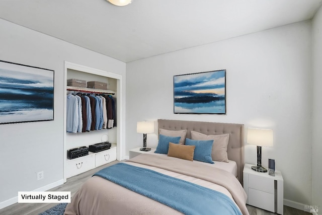 bedroom featuring baseboards, a closet, and wood finished floors