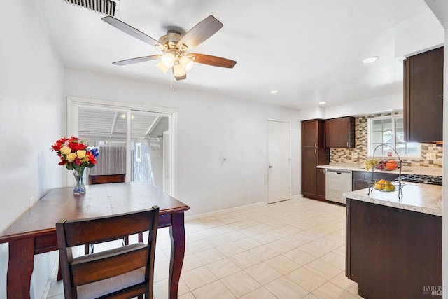 kitchen featuring visible vents, dark brown cabinetry, a ceiling fan, appliances with stainless steel finishes, and backsplash