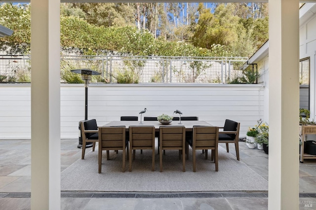 view of patio with outdoor dining space and fence