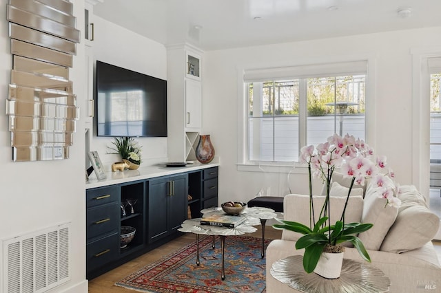 living room featuring wood finished floors and visible vents