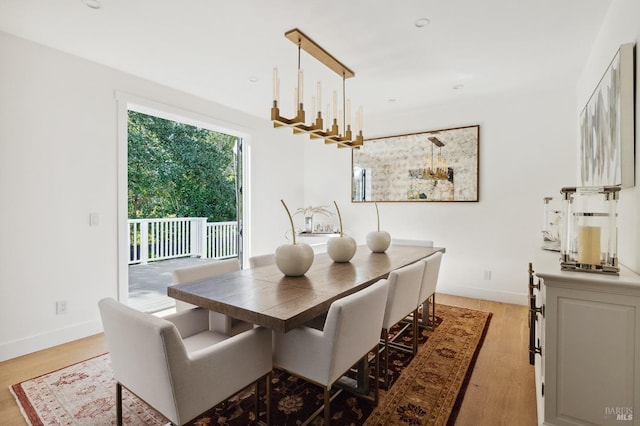 dining room featuring baseboards and light wood-type flooring