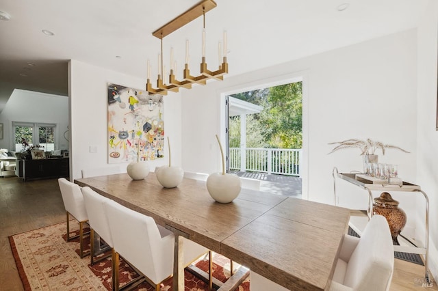 dining area featuring wood finished floors and a healthy amount of sunlight