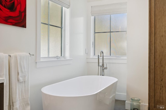 bathroom featuring a soaking tub