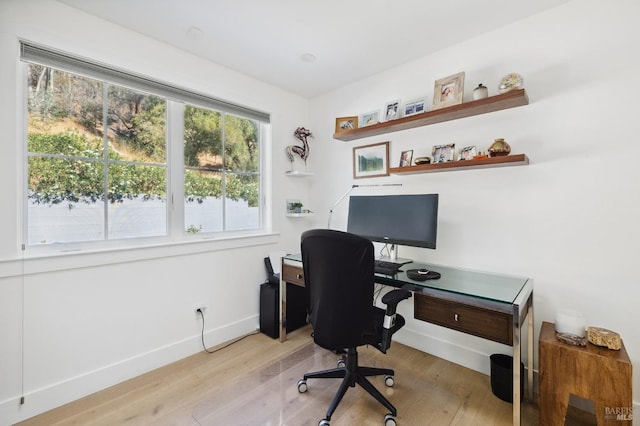 home office featuring baseboards and wood finished floors