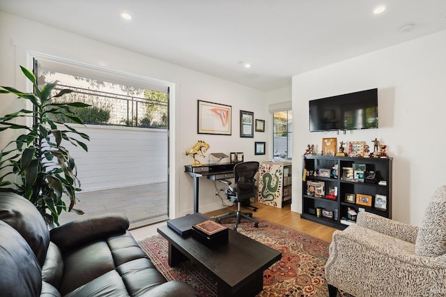 living area featuring wood finished floors and recessed lighting