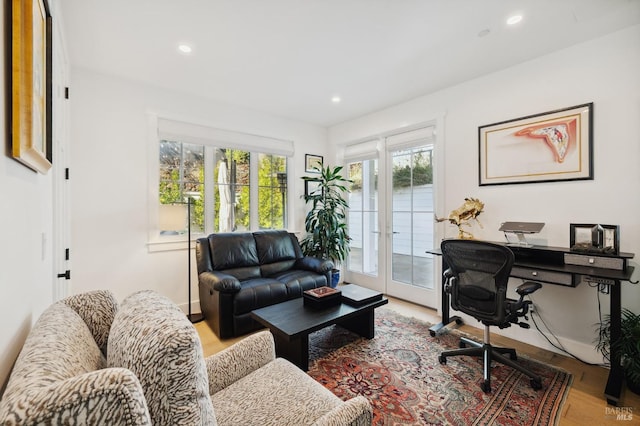 living room with french doors, recessed lighting, and light wood finished floors