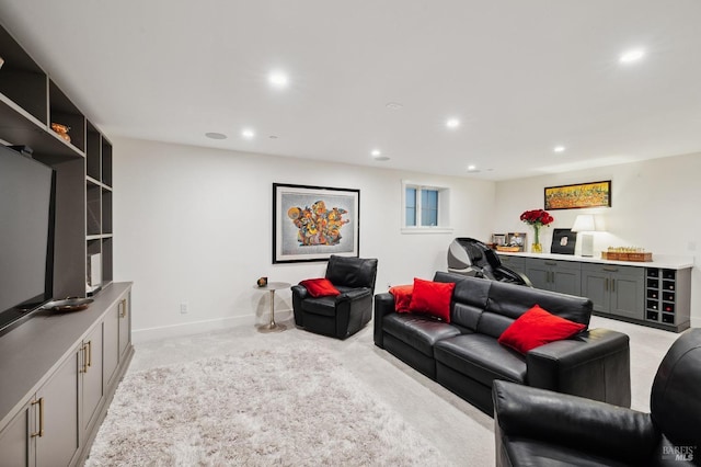 living room featuring light carpet, baseboards, and recessed lighting