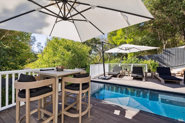 view of pool with fence, a wooden deck, outdoor dining area, a fenced in pool, and outdoor lounge area