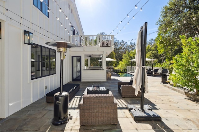 view of patio featuring a balcony and an outdoor living space