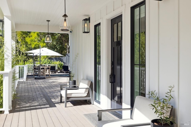 wooden terrace featuring outdoor dining area
