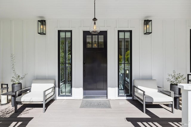 view of exterior entry featuring board and batten siding