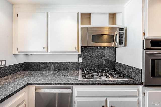kitchen featuring white cabinets, dark countertops, and stainless steel appliances