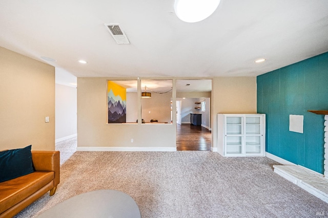 unfurnished living room with visible vents, baseboards, carpet flooring, and recessed lighting