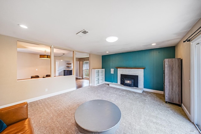 unfurnished living room featuring a fireplace, baseboards, visible vents, and carpet