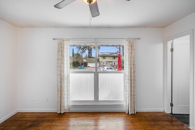 unfurnished dining area with wood finished floors, baseboards, and ceiling fan