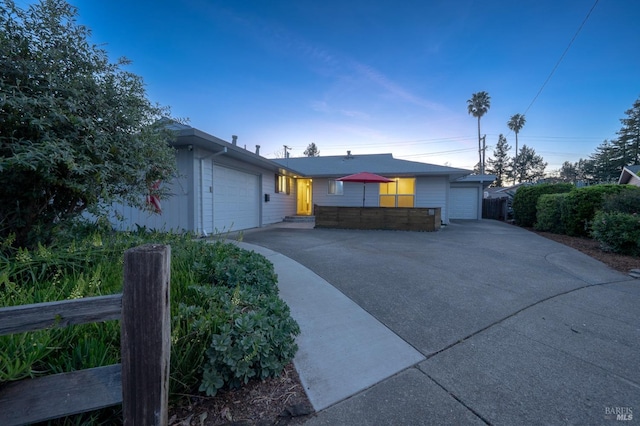 ranch-style home with an attached garage and driveway
