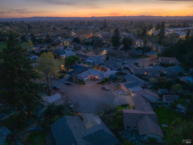 aerial view at dusk featuring a residential view