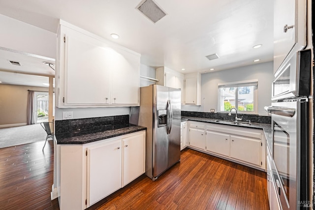kitchen featuring a wealth of natural light, stainless steel appliances, visible vents, and a sink
