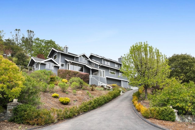 155 Hidden Valley Ln, San Anselmo, CA 94960 - view of front of home featuring a garage and a chimney