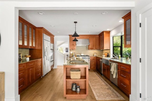 155 Hidden Valley Ln, San Anselmo, CA 94960 - kitchen with built in appliances, wall chimney exhaust hood, tasteful backsplash, light wood-style flooring, and a kitchen island with sink