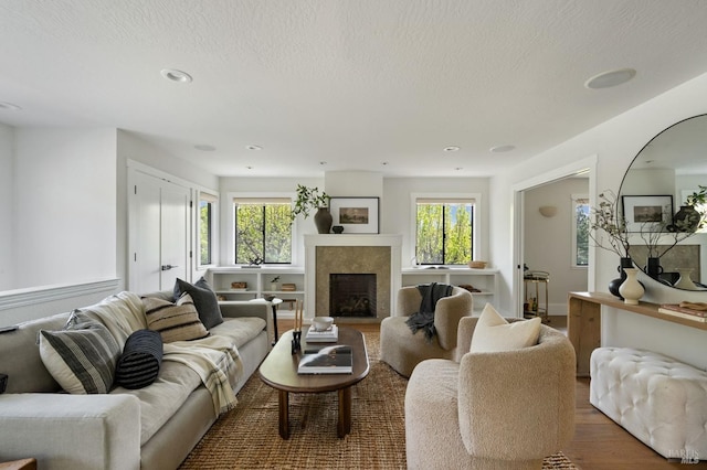155 Hidden Valley Ln, San Anselmo, CA 94960 - living area featuring a textured ceiling, a fireplace, wood finished floors, and a healthy amount of sunlight