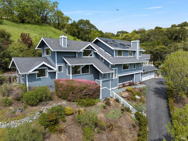 155 Hidden Valley Ln, San Anselmo, CA 94960 - shingle-style home featuring driveway, a chimney, a garage, and roof with shingles