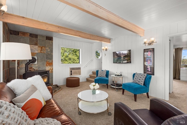 carpeted living room with an inviting chandelier, a wood stove, heating unit, and beam ceiling