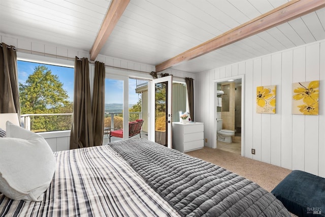 bedroom featuring carpet floors, multiple windows, and beam ceiling