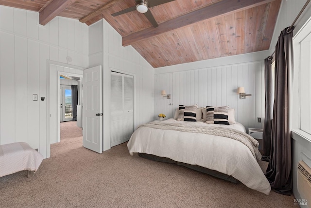 carpeted bedroom with a closet, lofted ceiling with beams, wood ceiling, and ceiling fan