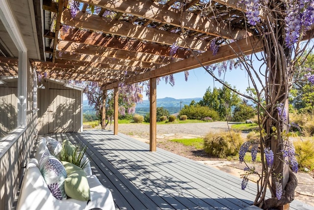 wooden deck featuring a pergola and a mountain view