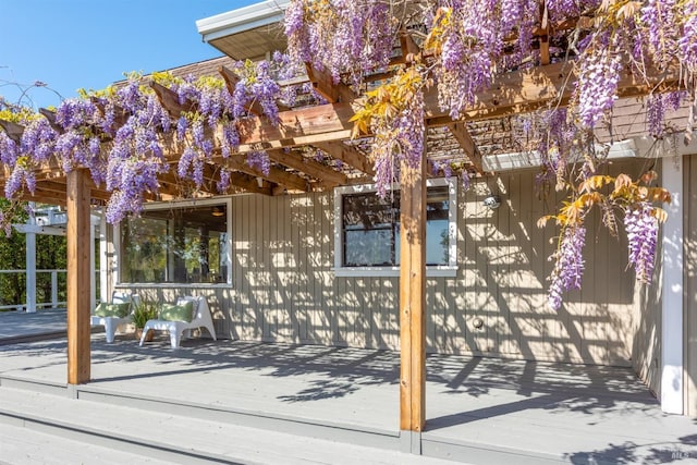 exterior space featuring a wooden deck and a pergola