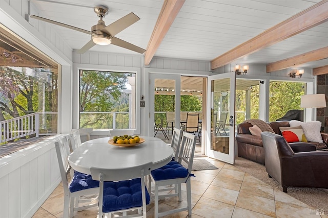 sunroom featuring ceiling fan, beam ceiling, and tile patterned flooring