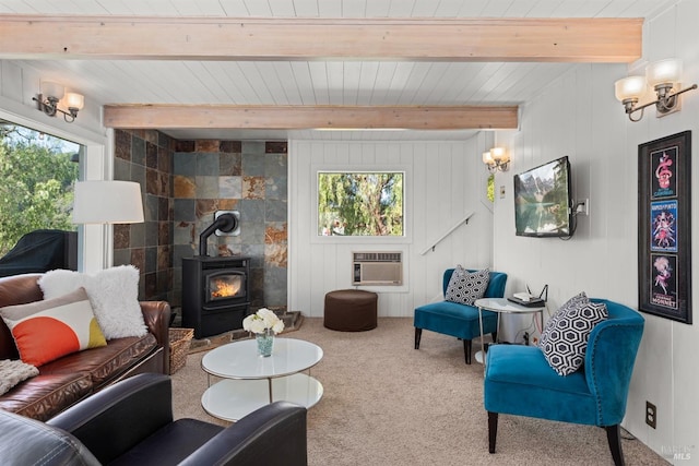 carpeted living area with wooden ceiling, beam ceiling, a wood stove, and a wall mounted air conditioner