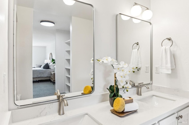 bathroom featuring double vanity, ensuite bathroom, and a sink