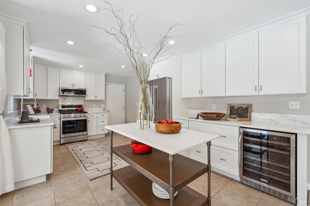 kitchen with wine cooler, white cabinetry, stainless steel appliances, and recessed lighting