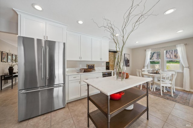 kitchen featuring white cabinetry, light countertops, high quality fridge, and recessed lighting