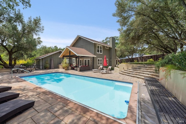 view of pool with fence, an outdoor hangout area, a patio, and a fenced in pool