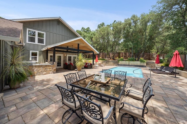 view of swimming pool featuring a fenced backyard, outdoor dining space, a patio, and a fenced in pool
