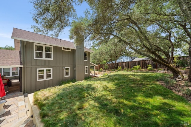 view of yard with fence and a patio area