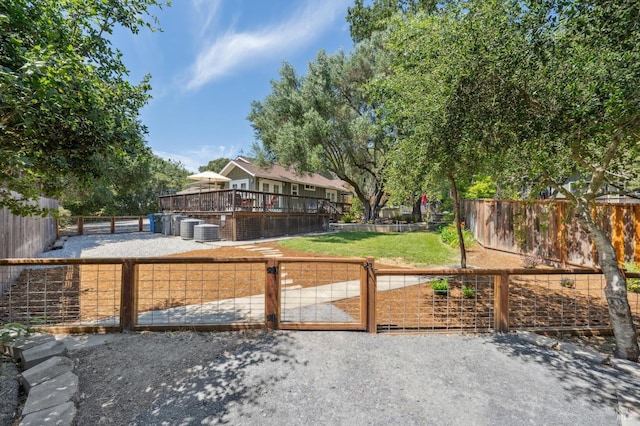 exterior space with central AC unit, a deck, and fence private yard