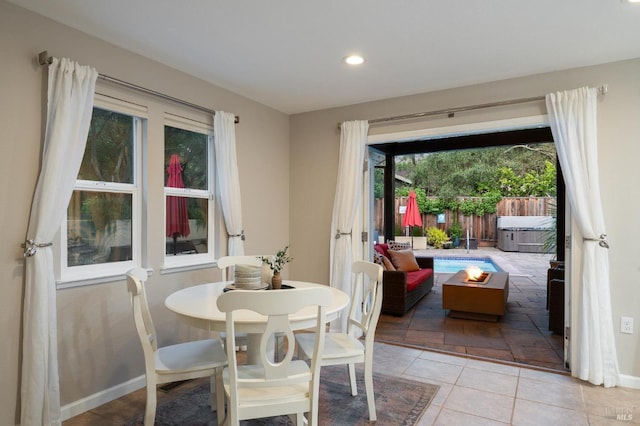 dining area with baseboards, recessed lighting, and light tile patterned floors
