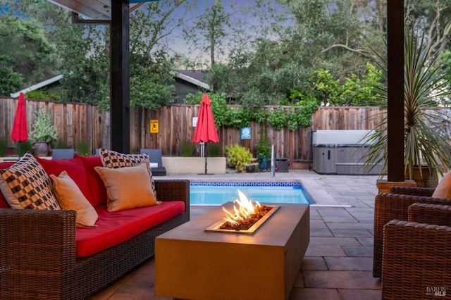 view of pool featuring a fenced backyard, an outdoor living space with a fire pit, and a patio