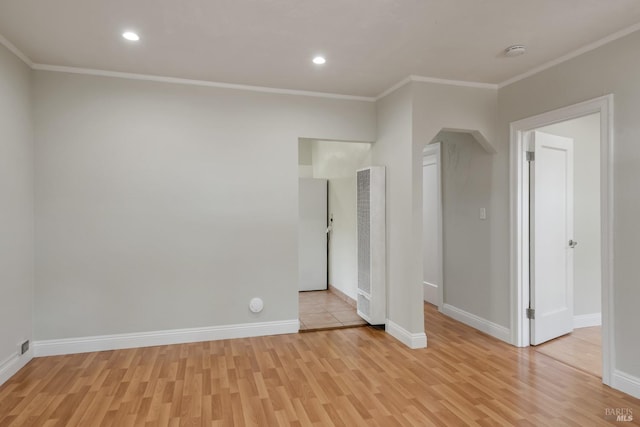 unfurnished room with baseboards, light wood-type flooring, crown molding, and recessed lighting