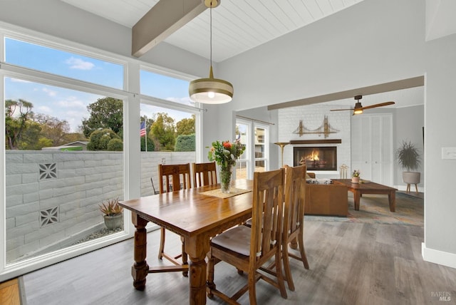 148 Kerns Ct, Napa, CA 94558 - dining area with a brick fireplace, wood finished floors, beamed ceiling, and ceiling fan
