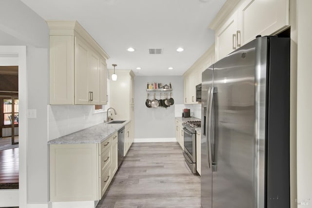 148 Kerns Ct, Napa, CA 94558 - kitchen featuring stainless steel appliances, light wood-type flooring, tasteful backsplash, light stone countertops, and a sink