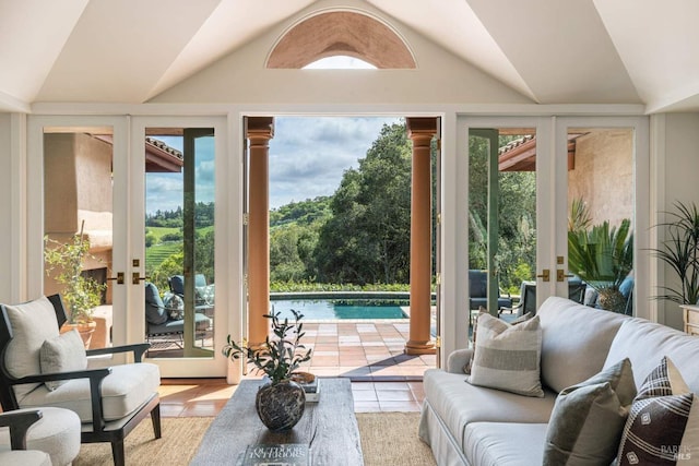 doorway with lofted ceiling and french doors